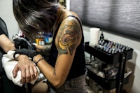 a woman getting a tattoo at a tattoo shop