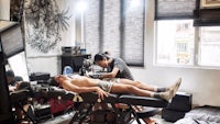 a man getting tattooed in a tattoo shop